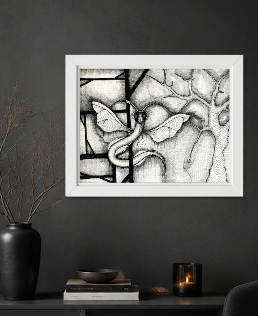 Dragonakee printable black ink drawing, originally hand-drawn by MatiArtBox, displayed in a white frame on a charcoal-grey wall above a dark cabinet in a moody modern interior.