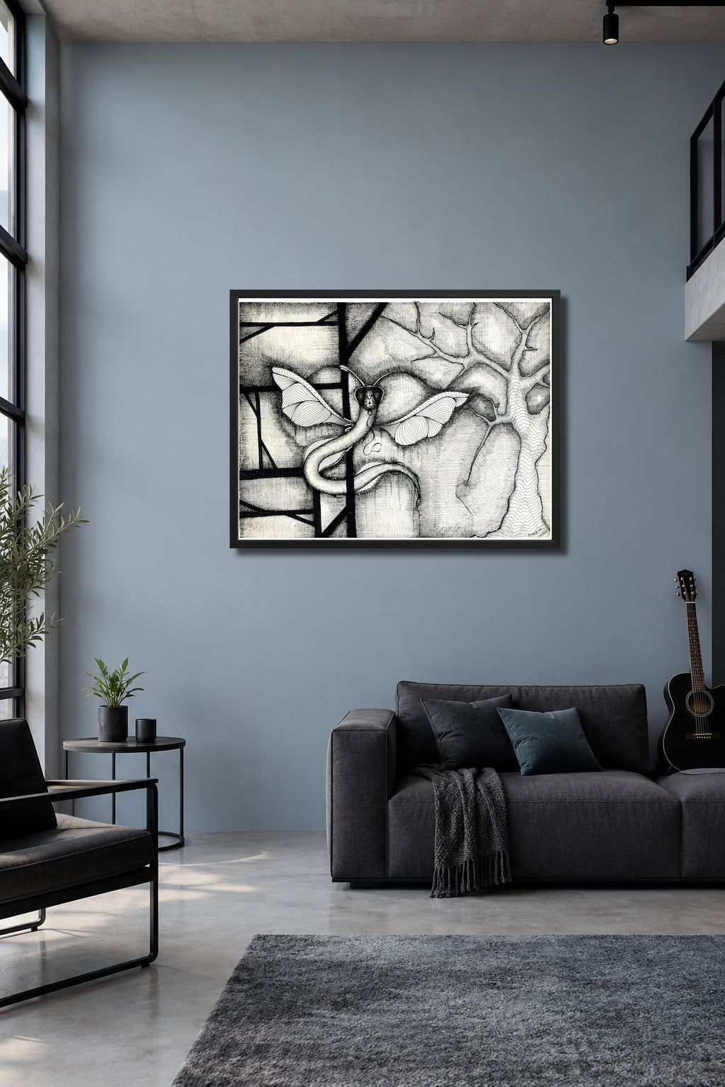 Dragonakee by MatiArtBox printable wall art mockup showing a framed black-and-white hand-drawn artwork above a dark gray sofa in a modern blue-gray room. 