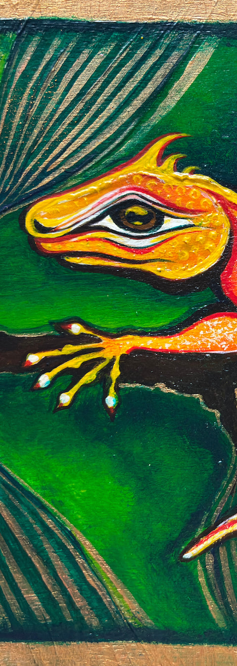 Close-up detail of Reptilla Vulgaris Rex printable wall art, created from an original hand-painted artwork by MatiArtBox, showing the orange lizard, painted gold accents and textured wooden surface.