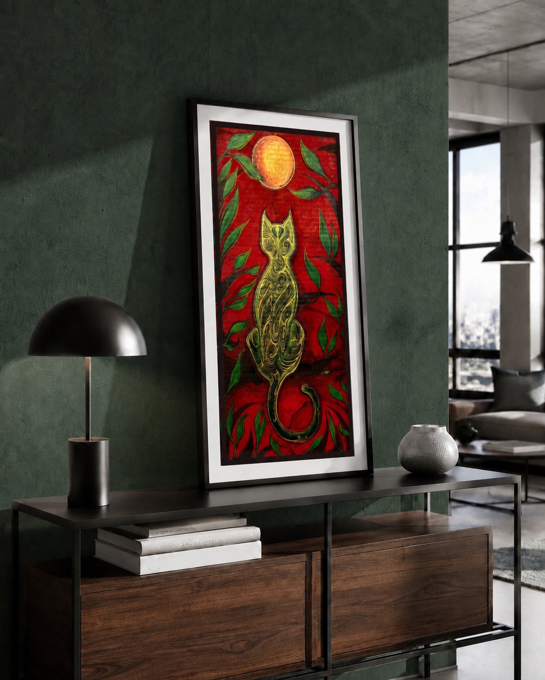 The Green Cat and the Golden Moon artwork by MatiArtBox displayed in a black frame above a wooden console against a dark green wall in a modern interior.